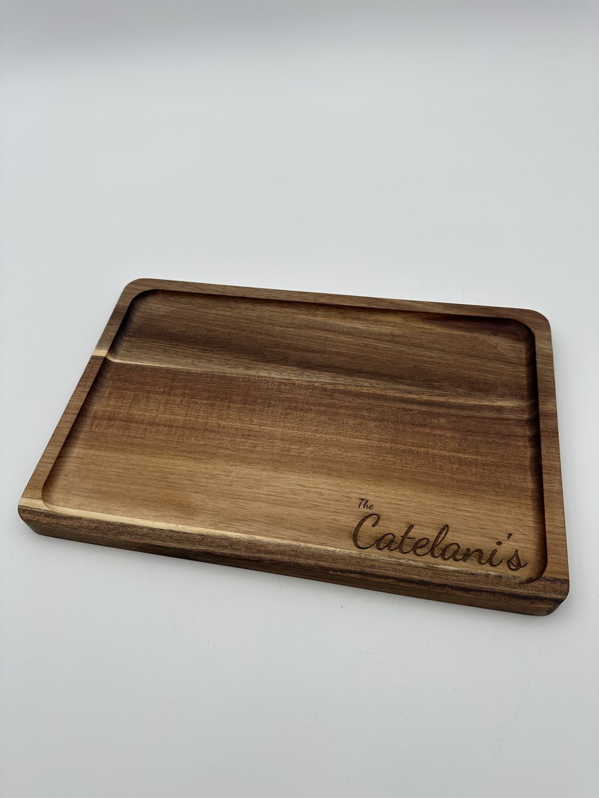 Close-up of engraved acacia cutting board wood grain